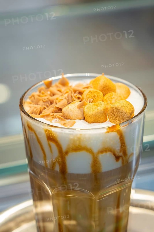 A drink with caramel and foam topping in a glass with a straw, autumn creations, Cafe Kuh, Deckenpfronn, Black Forest, Germany, Europe