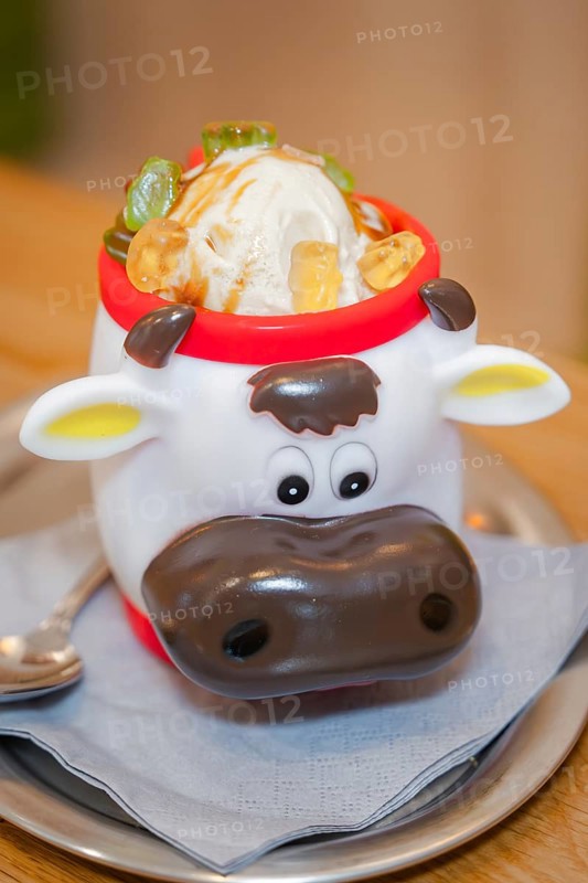 Ice cream in a cute cow cup with pieces of fruit, served on a table, autumn creations, Cafe Kuh, Deckenpfronn, Black Forest, Germany, Europe