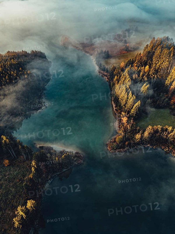Autumn sunrise in the foothills of the Alps with fog at Illasbergsee and Forggensee near Halblech in Allgäu, Bavaria, Germany, Europe