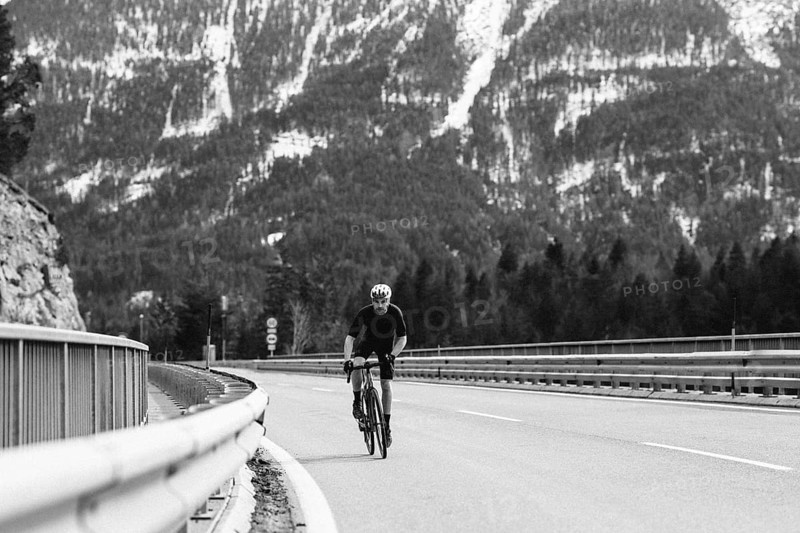 Road bike rider in spring between Lechtal and Tannheimer Tal in front of picturesque scenery of the Alps, Tyrol, Austria, Europe