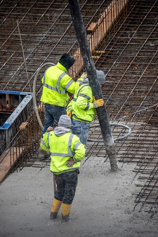 Construction site, concreting, the foundation of a building is concreted, the concrete is pumped onto the reinforced concrete mats