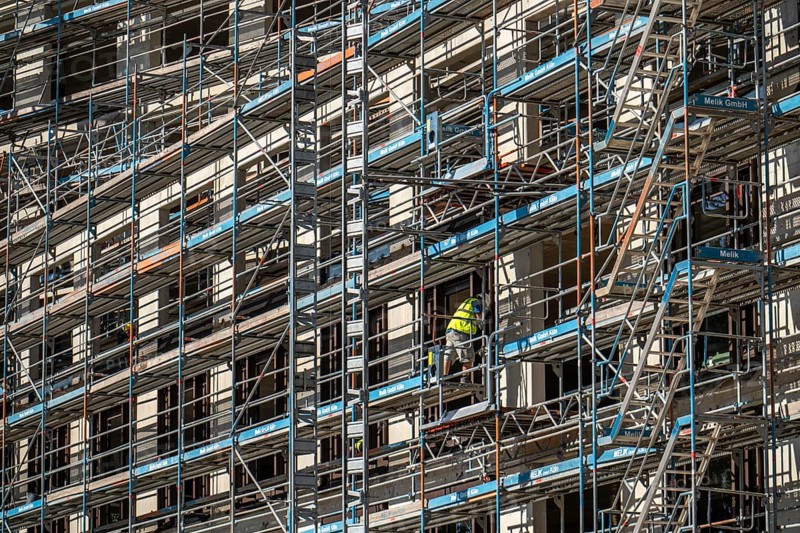 Construction site, at the Cologne Trade Fair Centre, new construction of a high-rise office building, construction cranes, facade of the shell, scaffolding, North Rhine-Westphalia, Germany, Europe