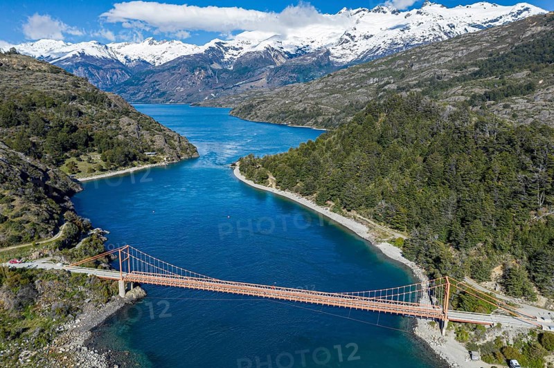 Aerial view of famous orange suspension bridge Puente General Carrera, bridge spans the connection between lake Lago General Carrera and lake Lago Bertrand, Patagonia, Chile, South America