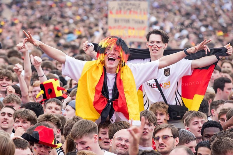 Football fans in the fan zone at the Brandenburg Tor during the quarter-final match between Germany and Spain at the European Football Championship, Berlin, 05/07/2024