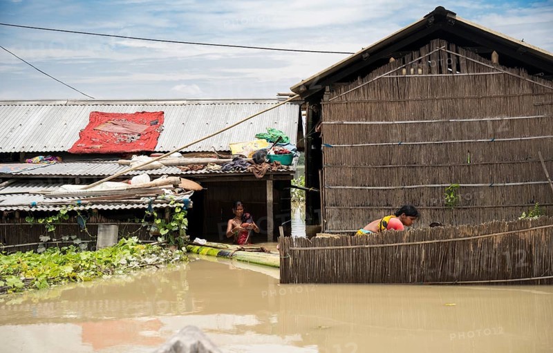 Morigaon, India. 4 July 2024. Residents in their flooded house, in a flood affected village in Morigaon district in India's northeastern state of Assam on July 4, 2024. Torrential rains and surging rivers across northeast India have killed at least nine people, with more than 1.5 million people affected