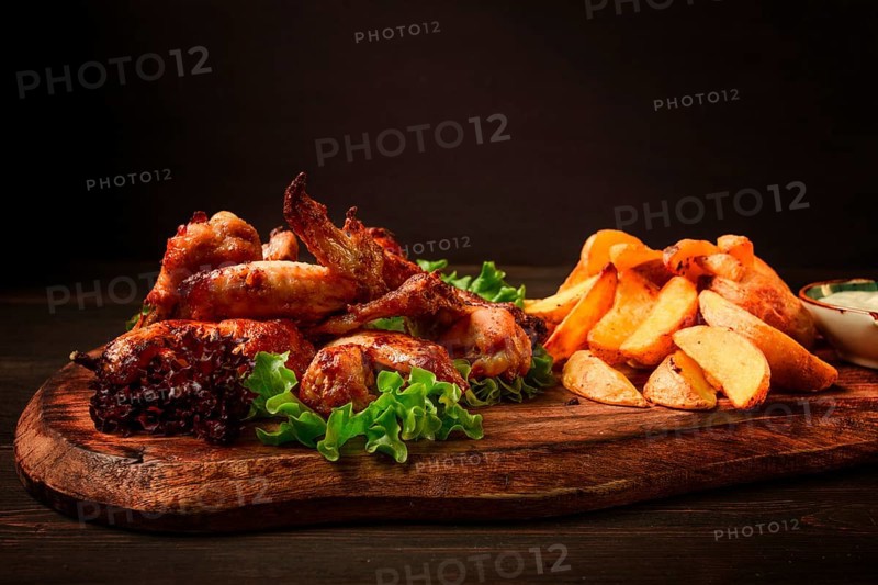 Fried chicken wings, with potatoes, and spices, homemade, fast food, no people
