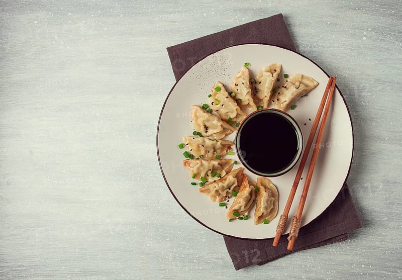 Japanese Gyoza dumplings, fried, with sauce, top view, without people, tinted, selective focus