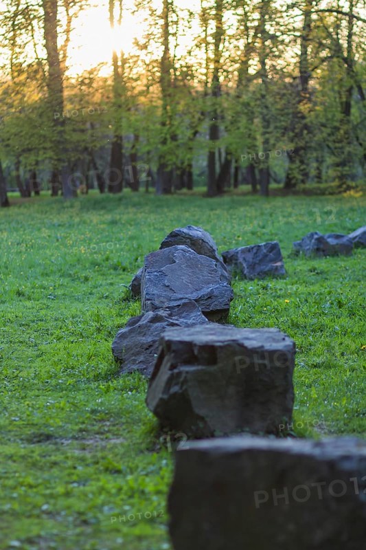 Old stones in the evening in the spring park