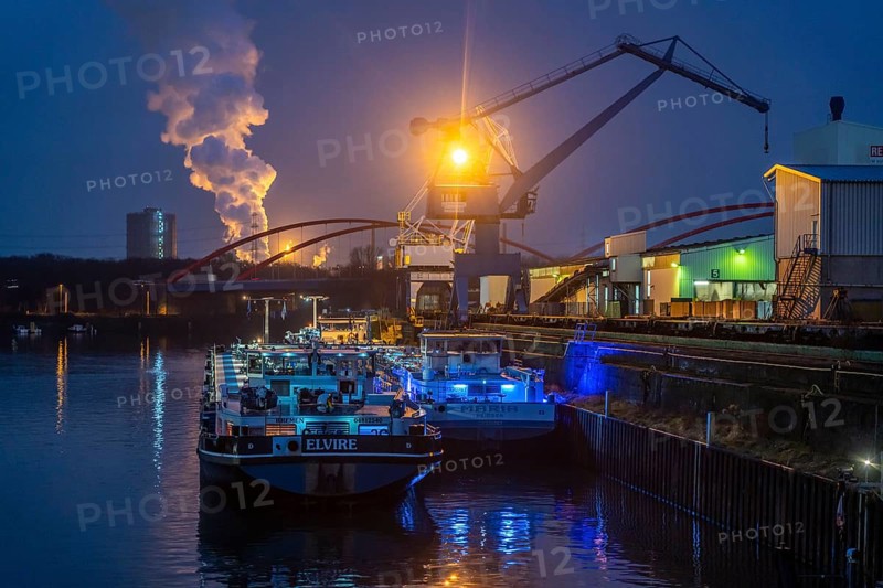 Cargo ships and cranes in Essen city harbour, on the Rhine-Herne Canal, motorway bridge of the A42 motorway, Emscher expressway, behind the Prosper coking plant in Bottrop, operated by the ArcelorMittal steel group, Essen North Rhine-Westphalia, Germany, Europe