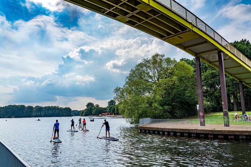 The Sechs-Seen-Platte, a local recreation area in the south of Duisburg, near the Wedau district, 6 former gravel pits, at Wolfssee, Yellow Bridge, Stand up Paddler, North Rhine-Westphalia, Germany, Europe