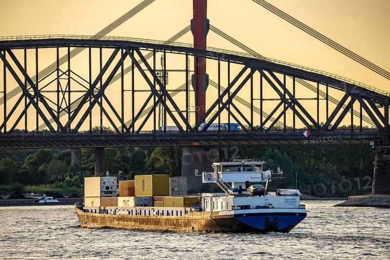 Container freighter Aqua Myra, cargo ships on the Rhine near Duisburg-Baerl, behind the Haus-Knipp railway bridge and the motorway bridge of the A42 over the Rhine, North Rhine-Westphalia, Germany, Europe
