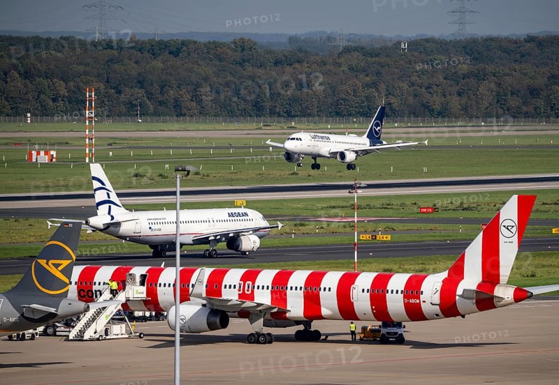 Düsseldorf Airport, Lufthansa Airbus on landing, Aegean Airlines Airbus A320-200 on the taxiway, Condor Boeing 757 in parking position