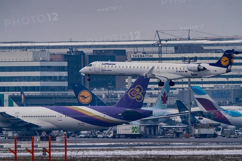 Lufthansa Cityline, Bombardier CRJ-900 approaching Frankfurt FRA airport, terminal building, Fraport, in winter, Hesse, Germany, Europe