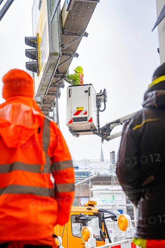 Construction worker working at a great height with a crane in the rain on a building site, Hermann Hesse railway construction site, Calw, Black Forest, Germany, Europe