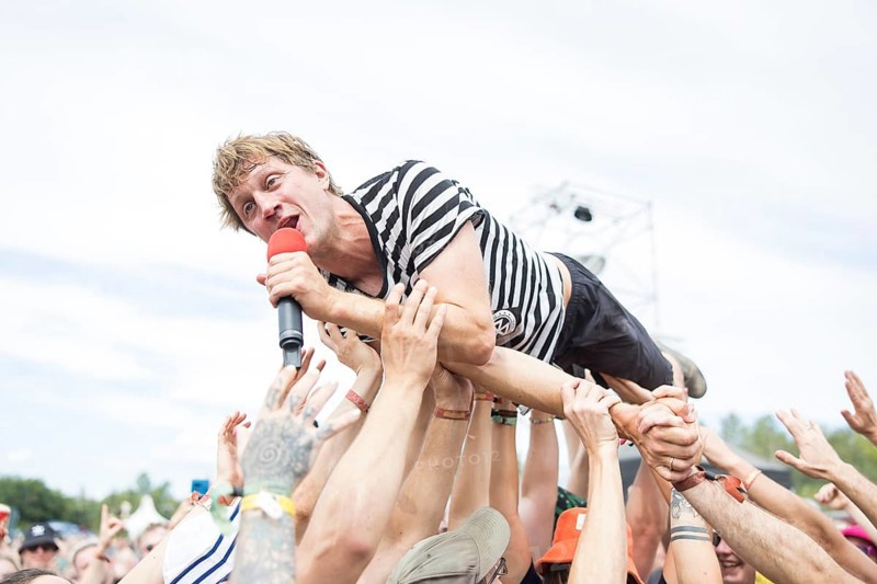 Beat Schmutz, singer of the band Schmutzki crowdsurfing on the beach in front of the Becks Beach Stage at the Highfield Festival on Saturday, Störmthaler See, 17/08/2024
