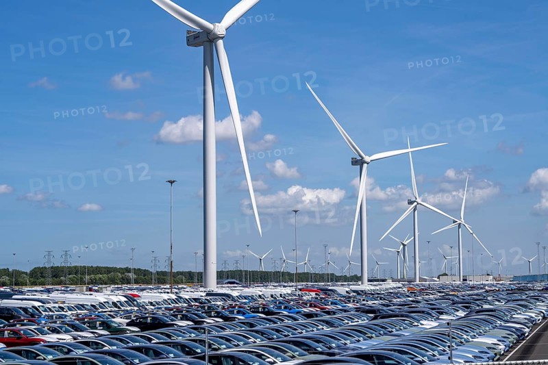 Storage area for new cars in the port of Vlissingen-Oost, vehicles are temporarily stored on over 100 hectares to ship them from Europe to the United Kingdom, Ford cars, others such as models from the Chinese car manufacturer BYD are delivered from here in Europe, wind farm, Netherlands