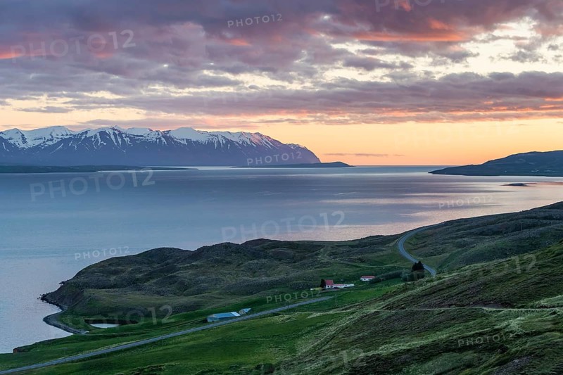 Snow-covered mountains, road and farm, sunrise over Eyjafjörður or Eyjarfjörður or Eyjafjördur, Iceland, Europe