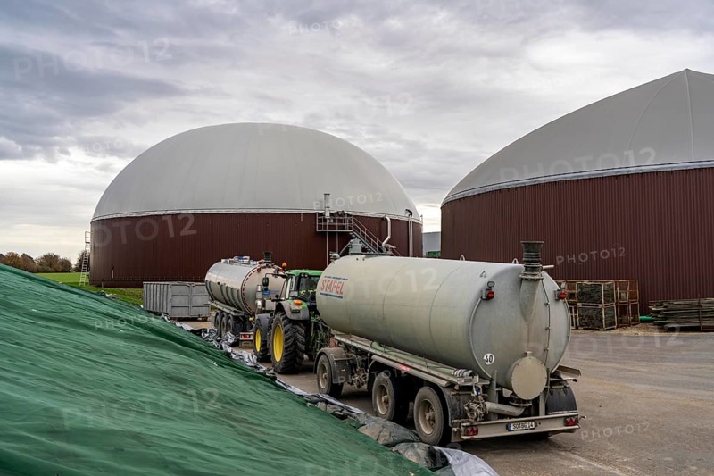 Biogas plant produces gas from various biomass, electricity is generated in combined heat and power plants with the biogas produced and sold to companies in the neighbouring industrial estate, the heat generated is fed into a local heating network, gas storage tanker for the delivery of liquid manure, Ense, North Rhine-Westphalia, Germany, Europe