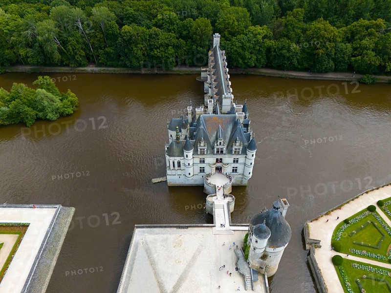 Aerial view of a castle in the river Cher, surrounded by dense forest with a view of the water and historical architecture, Chenonceau Castle, Château de Chenonceau, moated castle, Chenonceaux, France, Europe