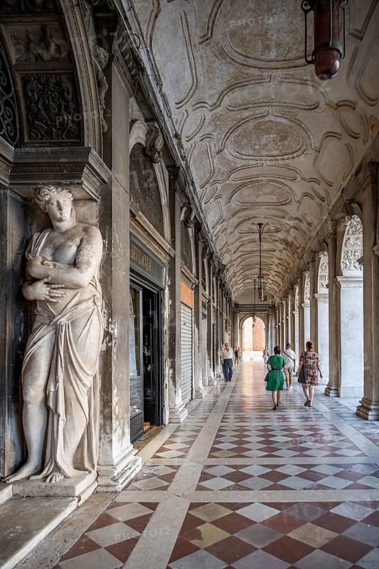 Statue of a woman in the arcades of St Mark's Square, Venice, Veneto, Italy, Europe