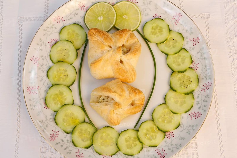 Southern German cuisine, trout cream in puff pastry, starter, fish dish, baked, from the oven, served on a plate, cucumber, lime slices, traditional cuisine reinterpreted, food photography, studio, Germany, Europe