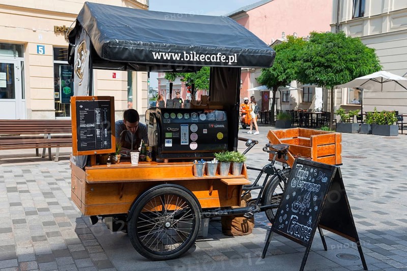 Mobile coffee stand on a bicycle, placed in a busy pedestrian zone in the sunshine, Lublin, Poland, Europe