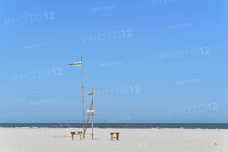 Pile dwelling on the extensive sandy beach, wooden piles with Juist flag, wooden planks with inscriptions, wooden benches, blue sky, North Sea, Juist, East Frisian Islands, Lower Saxony, Germany, Europe