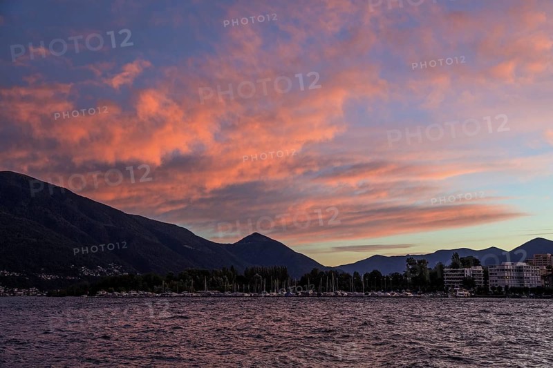 Locarno, Lake Maggiore, clouds coloured by evening light in the background, Canton Ticino, Switzerland, Europe
