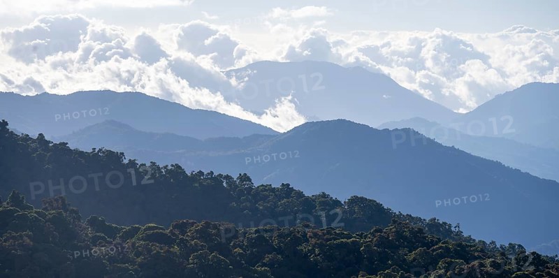 View of hills with cloud forest, Dramatic clouds between the mountains, Province of San José, Costa Rica, Central America