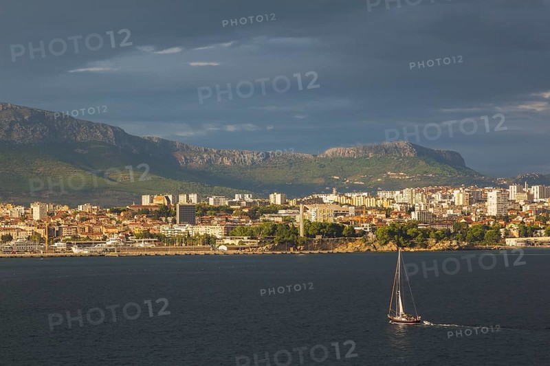 Sailboat on Adriatic sea heading towards the Dalmatian coast of Split at sunset in late summer, Croatia, Europe