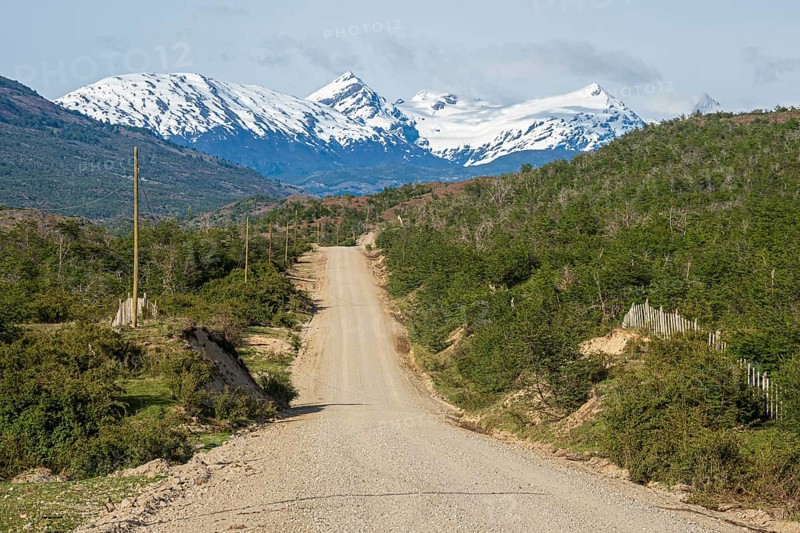 Road Carretera Austral north of Cochrane, gravel road in front of snowcovered mountains, Patagonia, Chile, South America