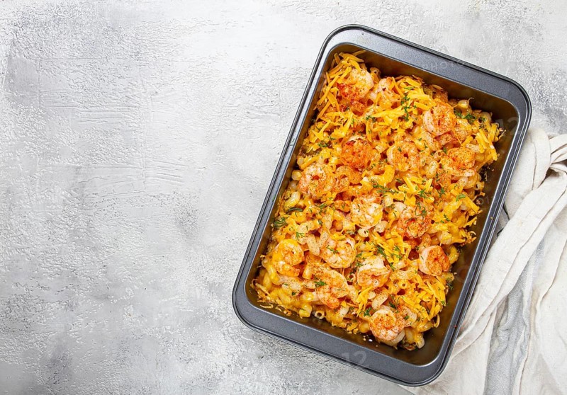 Pasta with shrimp and cheese, with a golden crust, cooked in a baking dish, homemade, no people