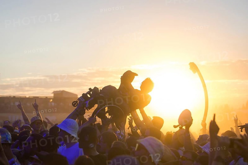 A wheelchair user crowdsurfing in front of sunset at the Highfield Festival on Friday, Störmthaler See, 16/08/2024
