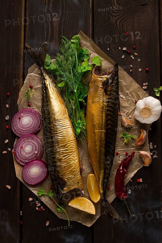 Smoked mackerel, top view, with spices, on a wooden table, no people, selective focus