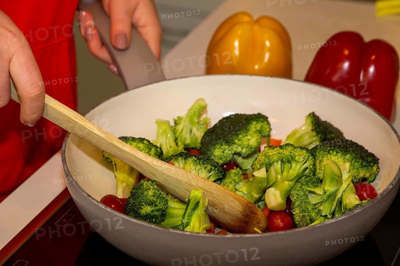 Vegan cooking: Close-up of a pan with broccoli, carrots and cocktail tomatoes
