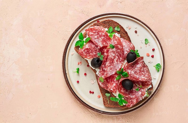 Sandwich, grain bread, with cream cheese and salami, black olives, micro-greens, top view, close-up, no people, Breakfast