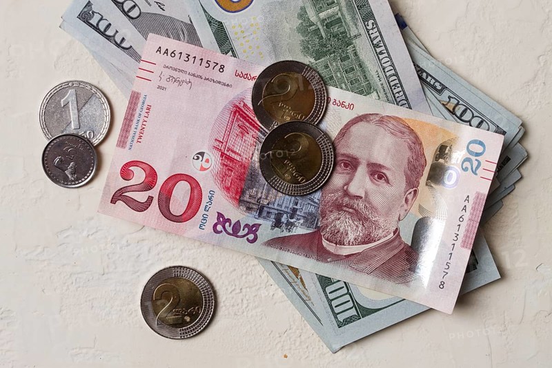 Lari, 20 GEL, Georgian monetary currency, with dollars, banknotes, top view, no people, on the table