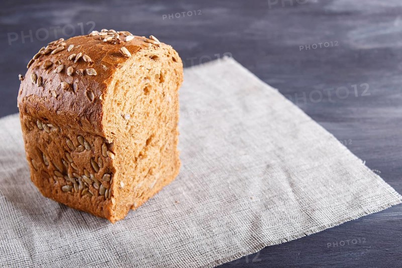 Cut rye bread on linen napkin. close up