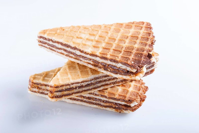 Waffle sandwiches with boiled condensed milk isolated on white background. closeup