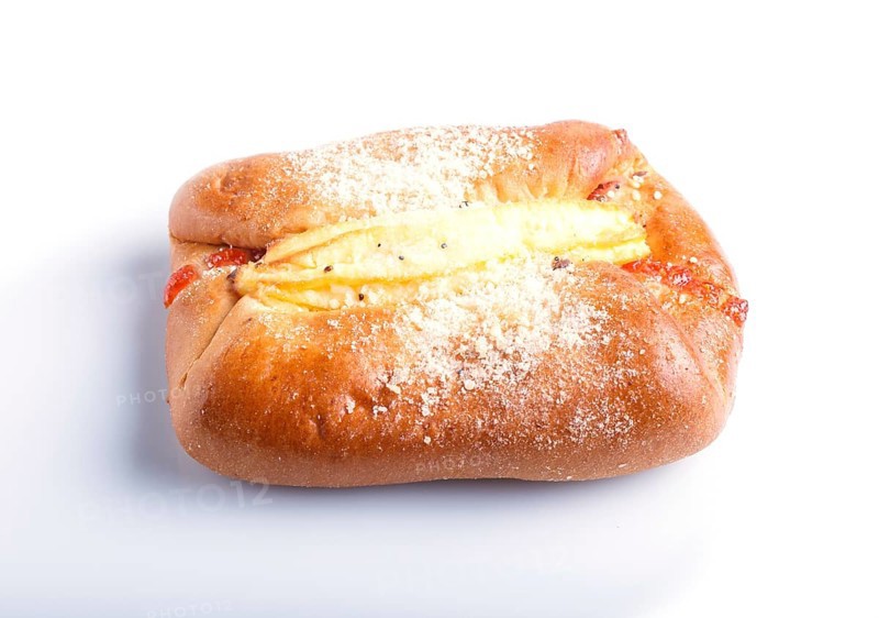 One bun with cream filling isolated on white background. close up