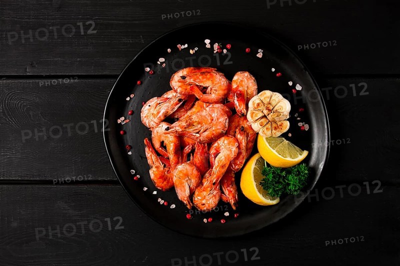 Fried shrimp, on a black background, top view, no people