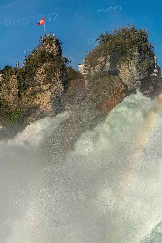 Rhine Falls seen from Laufen Castle, rocky island, Swiss flag, rainbow, spray, Canton of Zurich, on Neuhausen, Switzerland, Europe