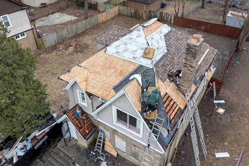 Detroit, Michigan, Workers replace a roof on a vacant house in the Morningside neighborhood. They were part of an effort by a nonprofit, the U Snap Bac Housing Corporation, to renovate several vacant houses in this street