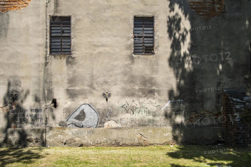 Wall graffiti on a dilapidated building, integrated into the old historic town wall of Namyslow (Namslau), Opole Voivodeship, Poland, Europe