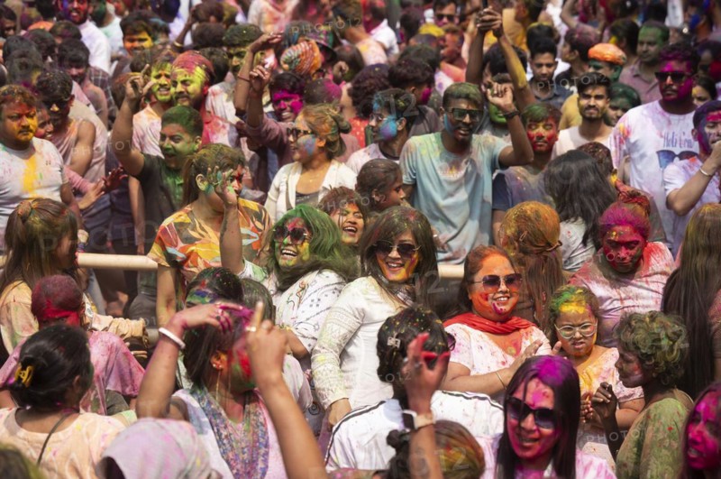 Revellers dancing in the beat of music as they celebrate Holi on a street, the Hindu spring festival of colours on March 25, 2024 in Guwahati, Assam, India. Holi, also known as the Festival of Colors or the Festival of Spring, is one of the most vibrant and joyous festivals in India