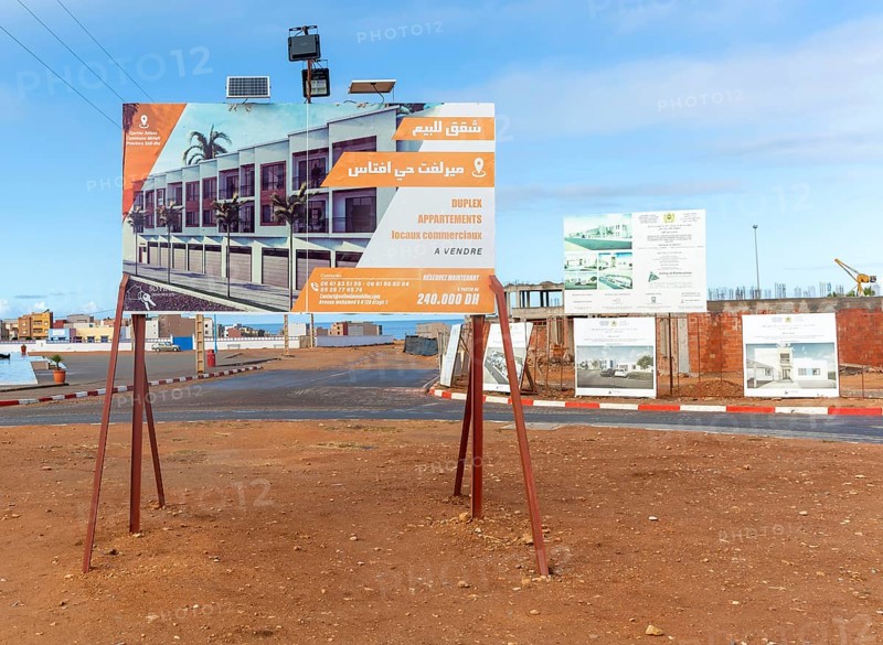 Estate agent real estate advertising sign for new duplex apartments, Mirleft, southern Morocco, North Africa