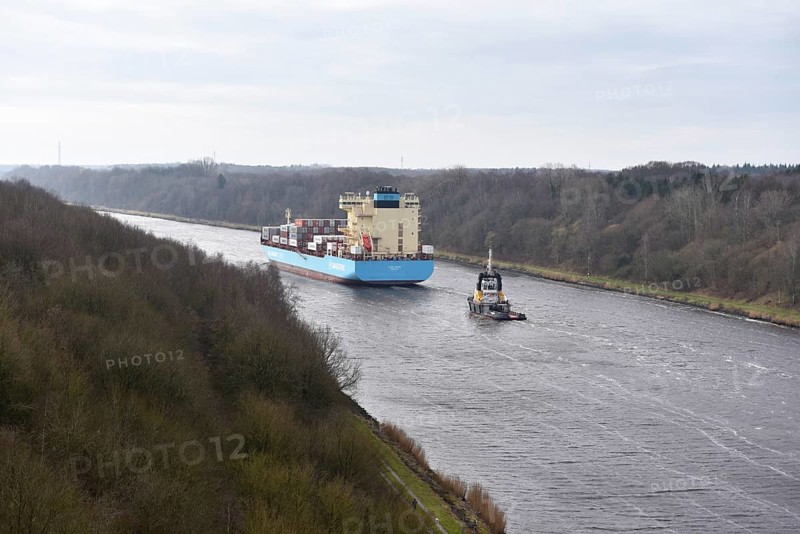 Container ship Laura Maersk is escorted by a tugboat in the Kiel Canal, Schleswig-Holstein, Germany, Europe