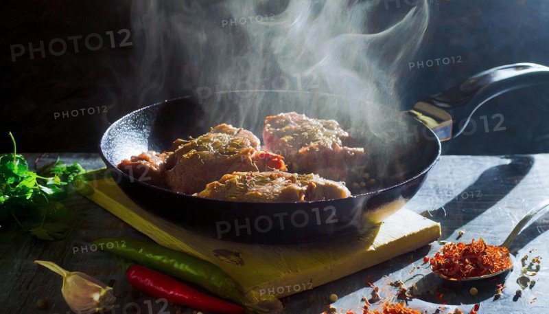 Delicious meat stakes cooked on a pan. Wooden cutting board with spices and oil, AI generated