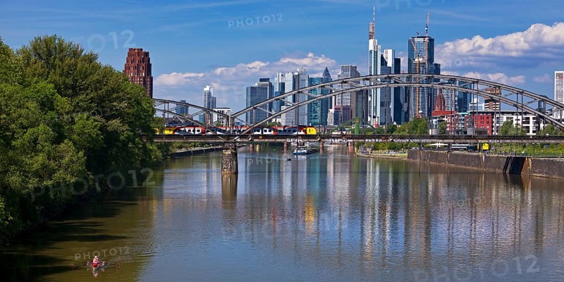 The river Main with regional railway on the Deutschherrnbrücke and the skyline of Frankfurt am Main, Hesse, Germany, Europe