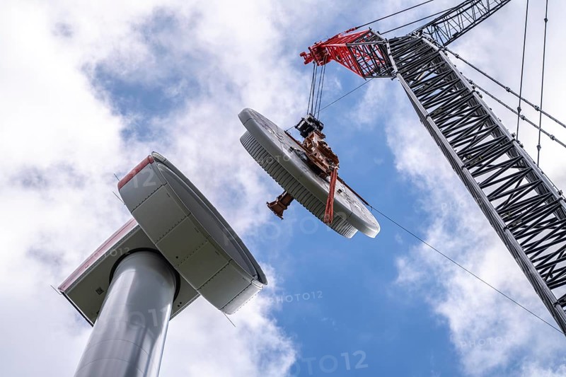 Erection of a wind turbine, wind energy plant, assembly of the ring generator, with a crawler lattice crane, wind farm near Hagen, North Rhine-Westphalia, Germany, Europe